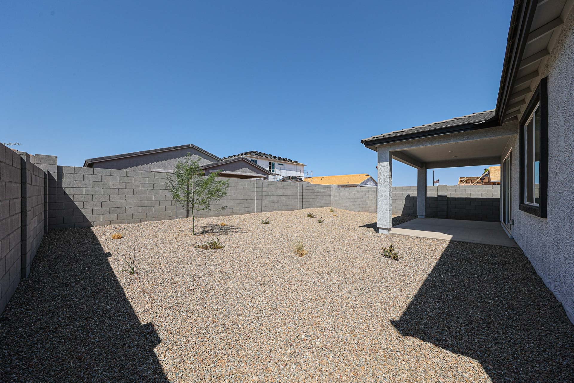 A dirt road between buildings.
