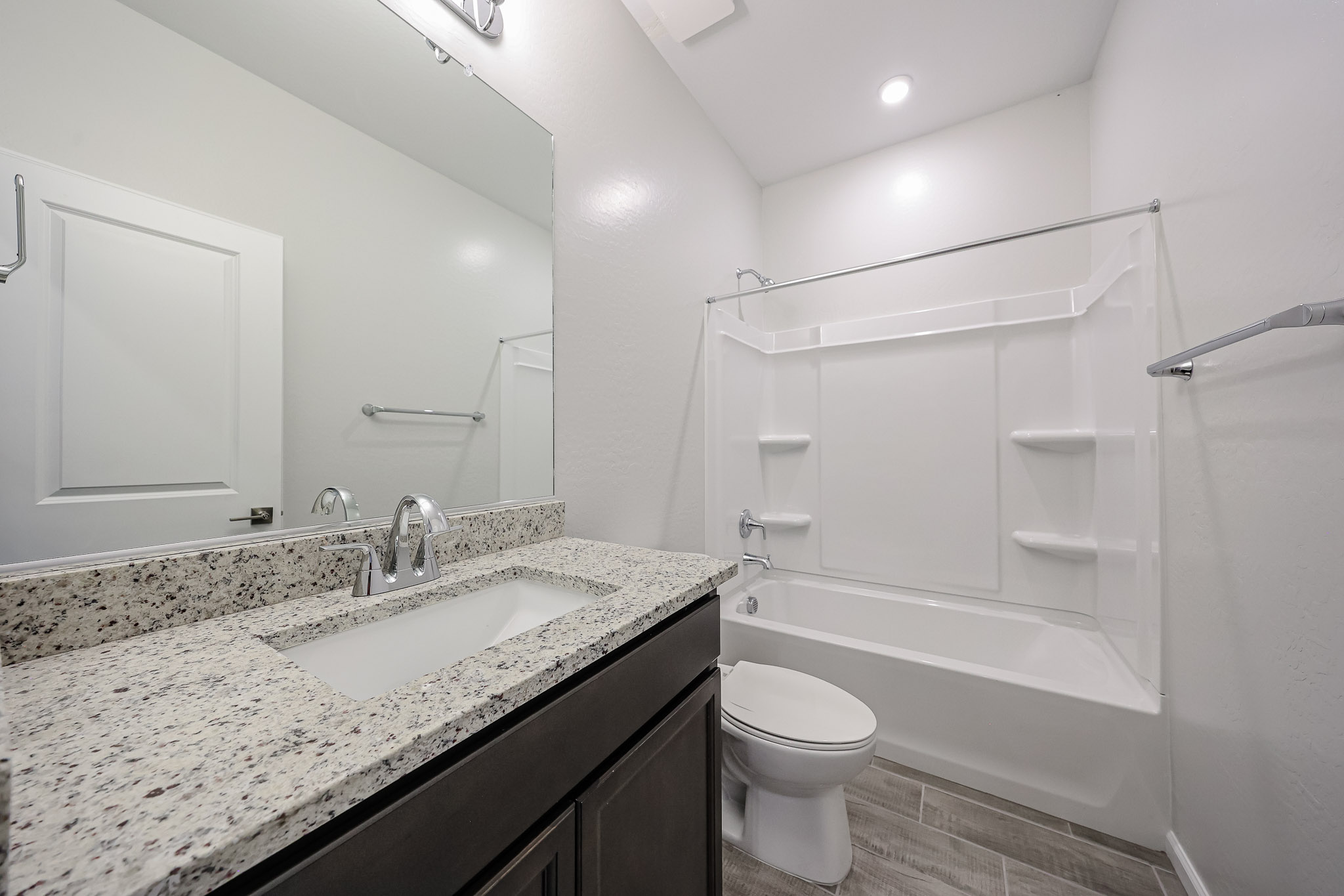A bathroom with a marble countertop.