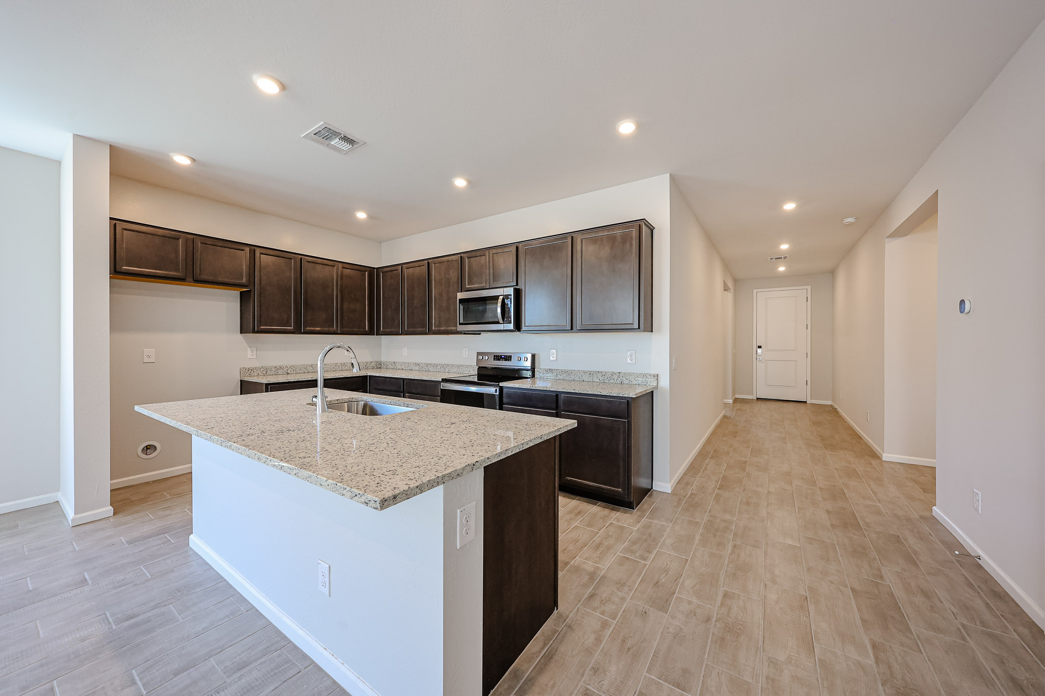 A kitchen with a marble counter top.