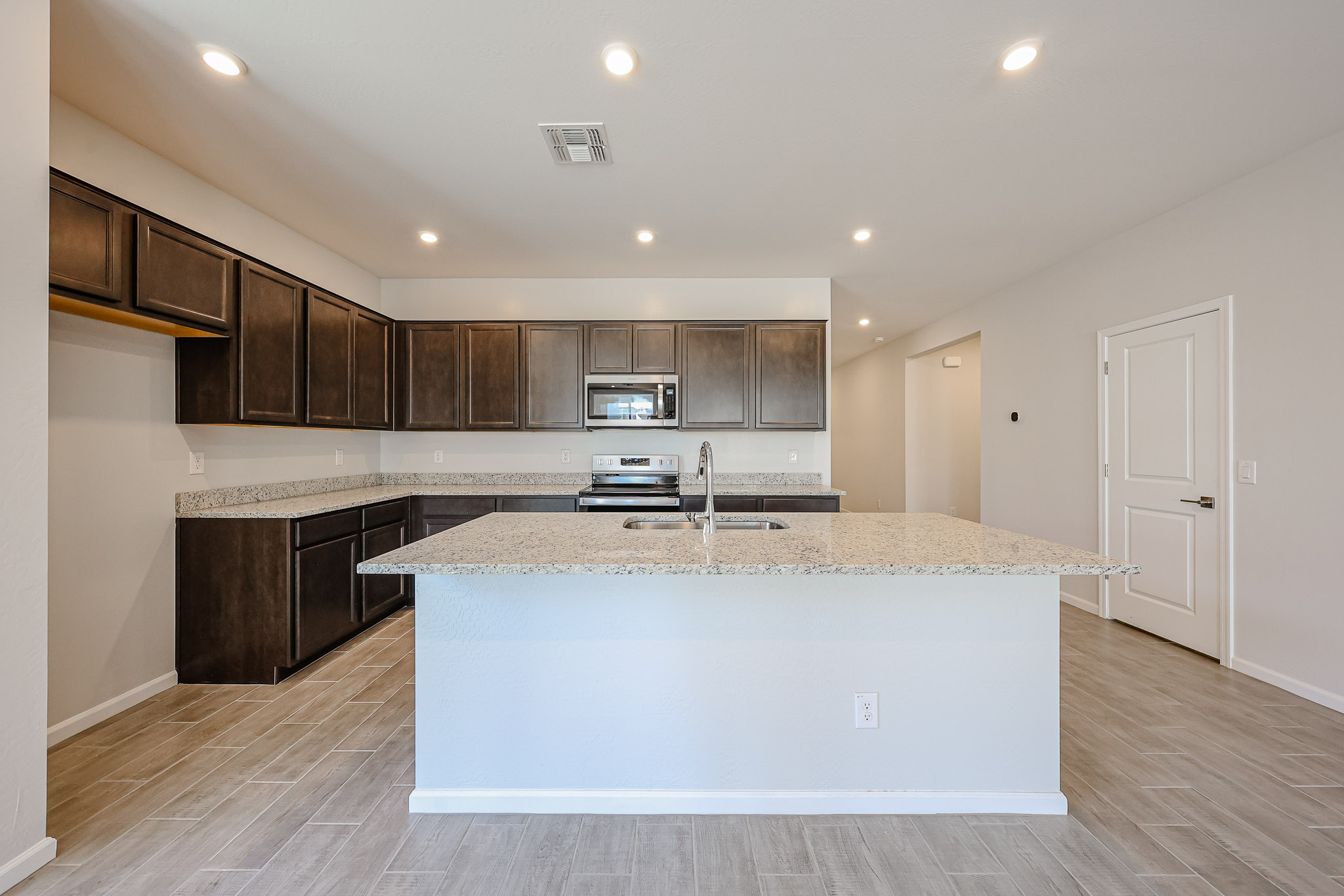 A kitchen with a marble counter top.