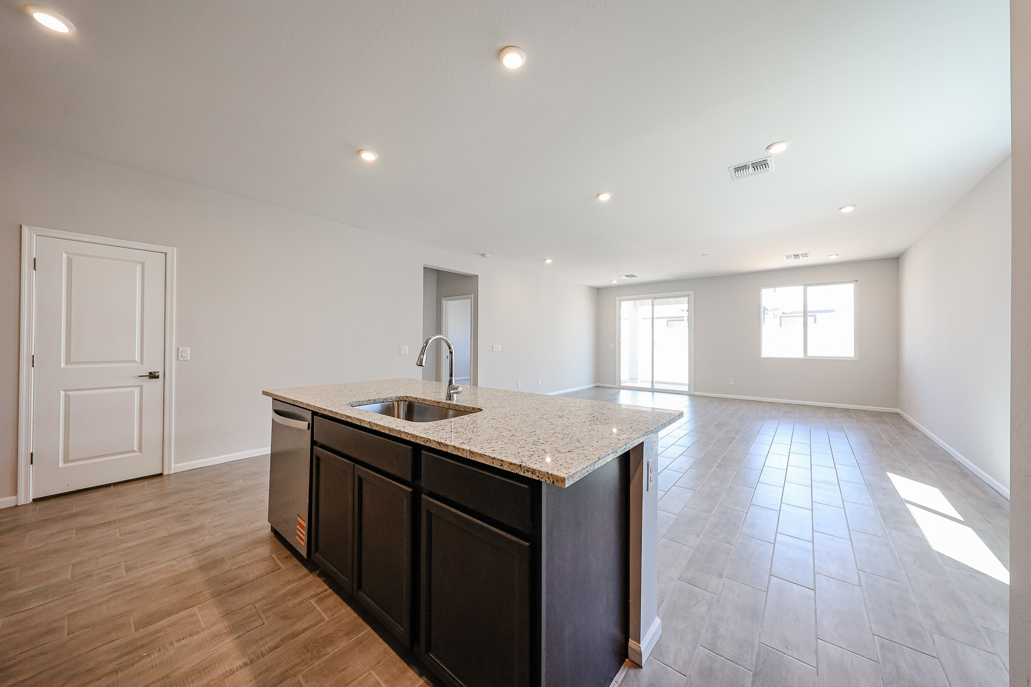 A kitchen with a marble counter top.