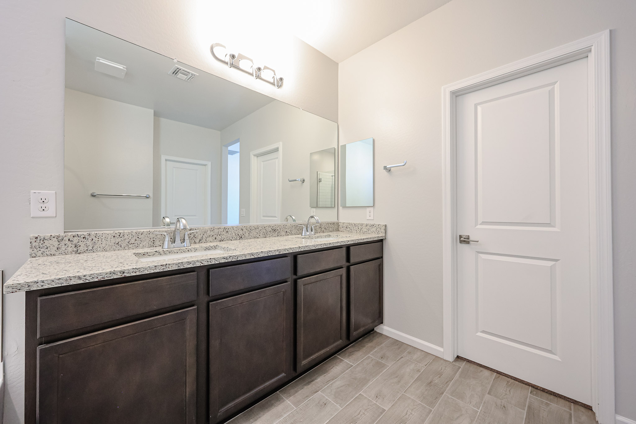 A bathroom with a large mirror.