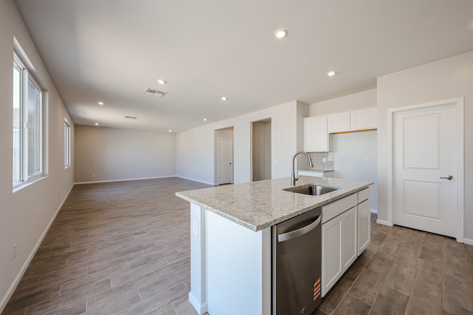 A kitchen with white cabinets.