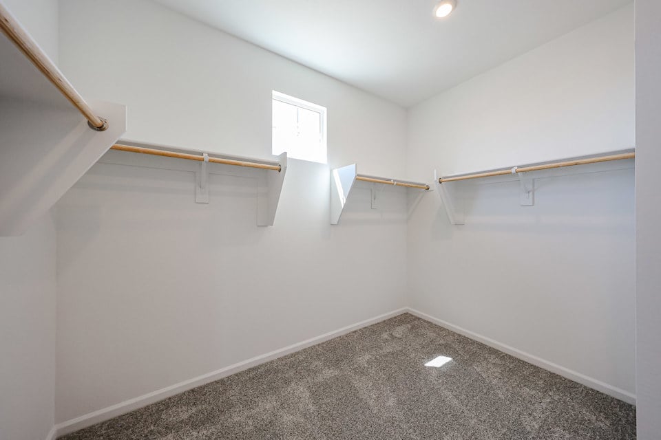 A white room with a black carpet.