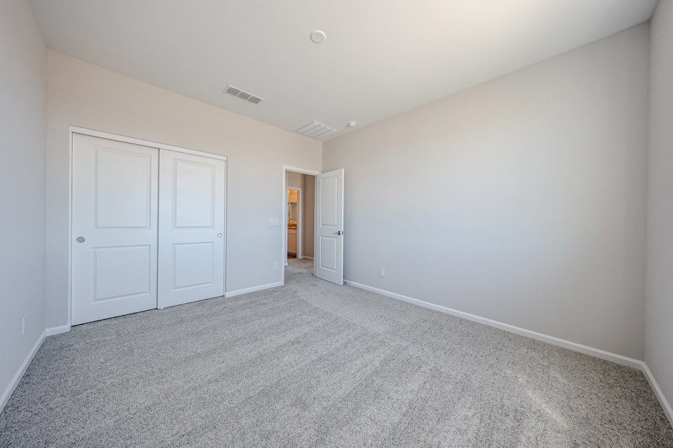 A hallway with white doors.