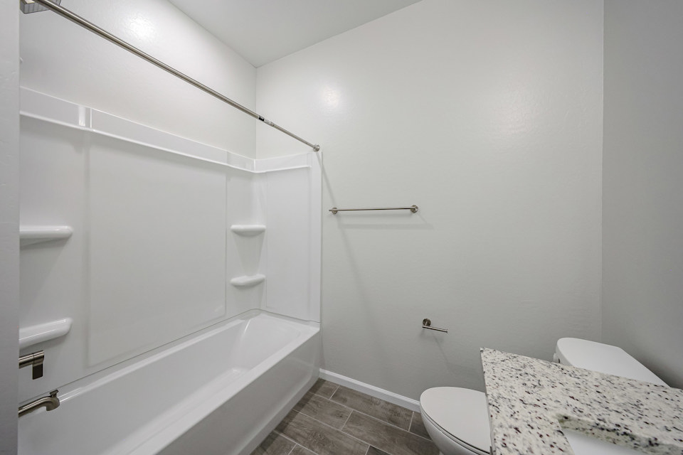 A bathroom with a bathtub toilet and shower.