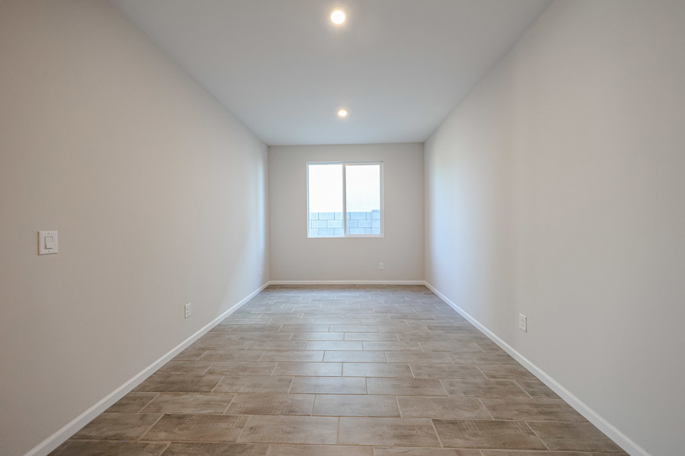 A room with a tile floor and a window.