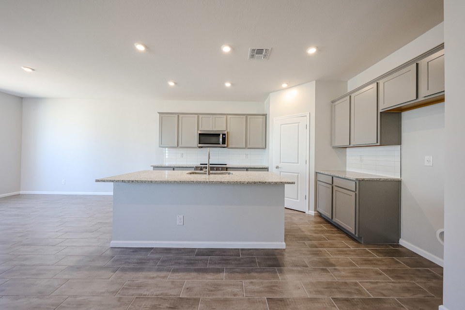 A kitchen with white cabinets.