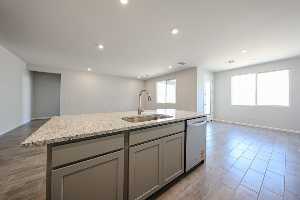 A kitchen with marble counters.