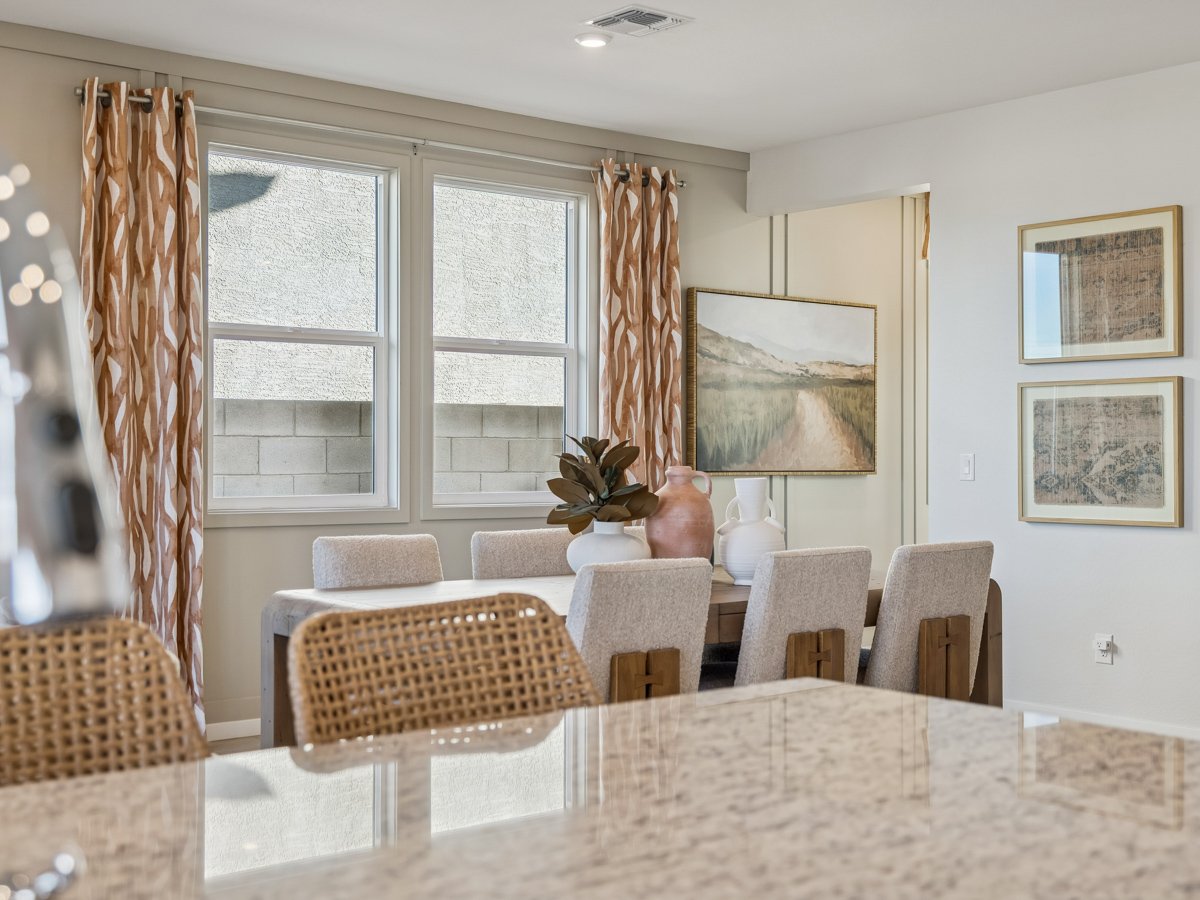 A dining room with a table set.