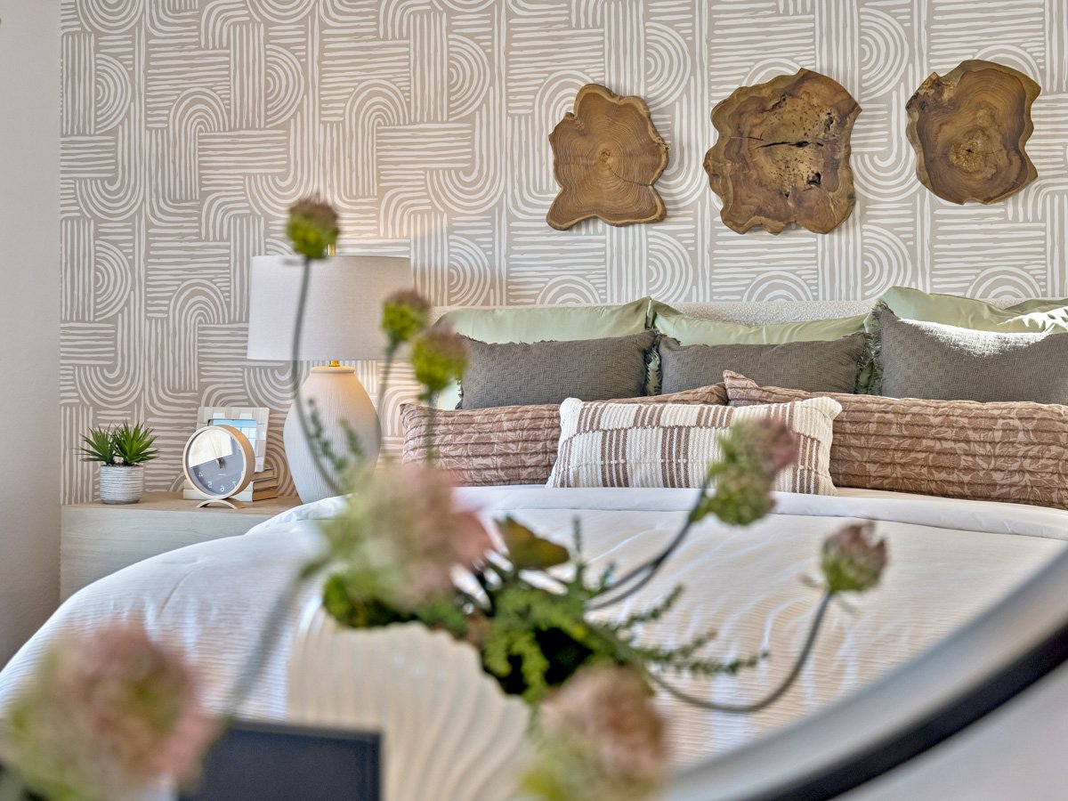 A table with a couch and a table with flowers on it.