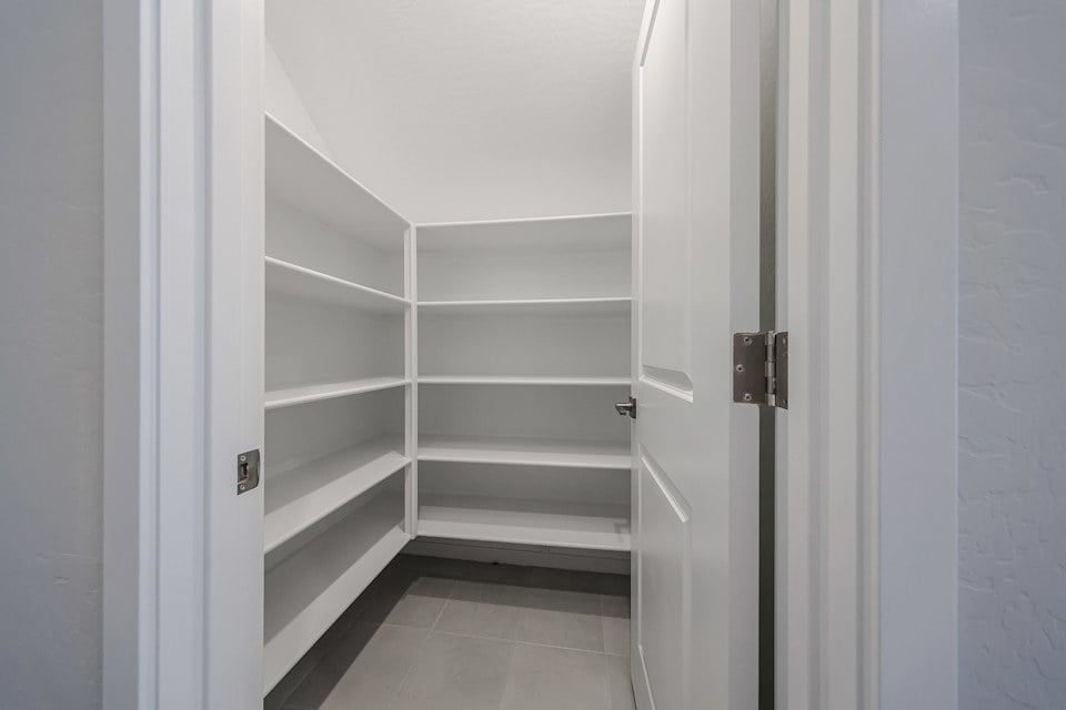 A white closet with white doors.