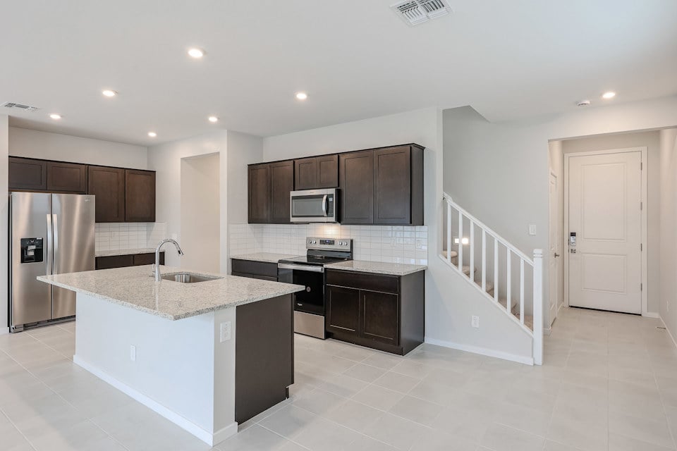 A kitchen with black cabinets.