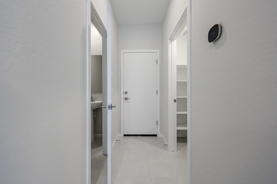 A hallway with white doors.