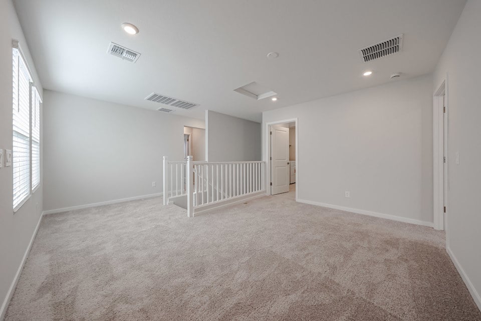 A room with a white railing and a white railing.