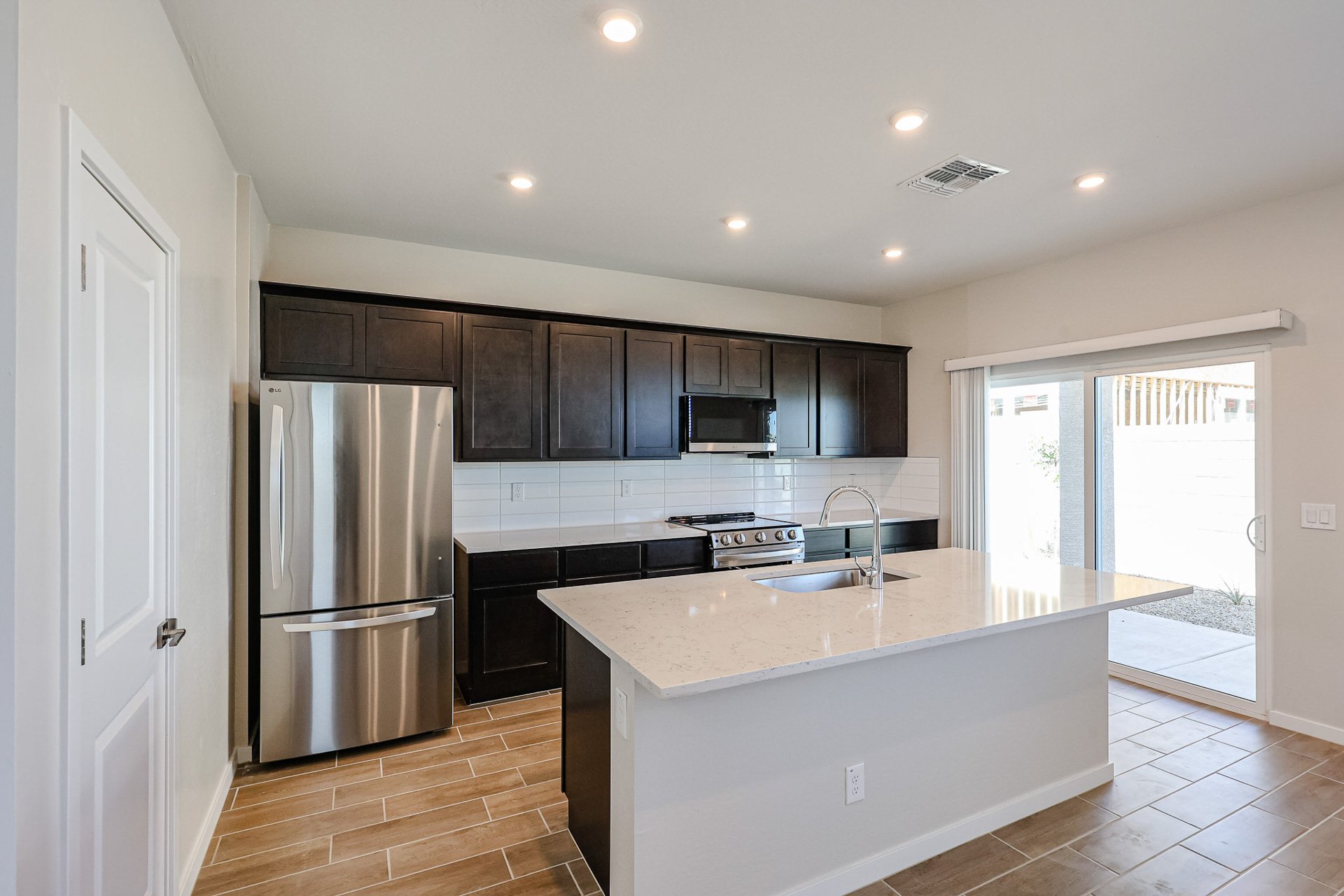 A kitchen with black cabinets.