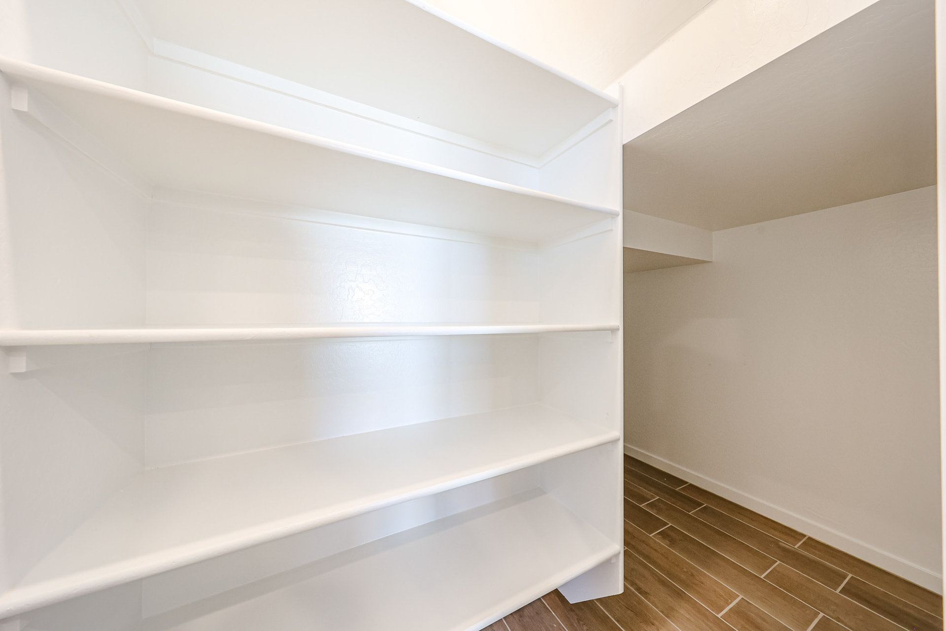 A white shelf in a room.