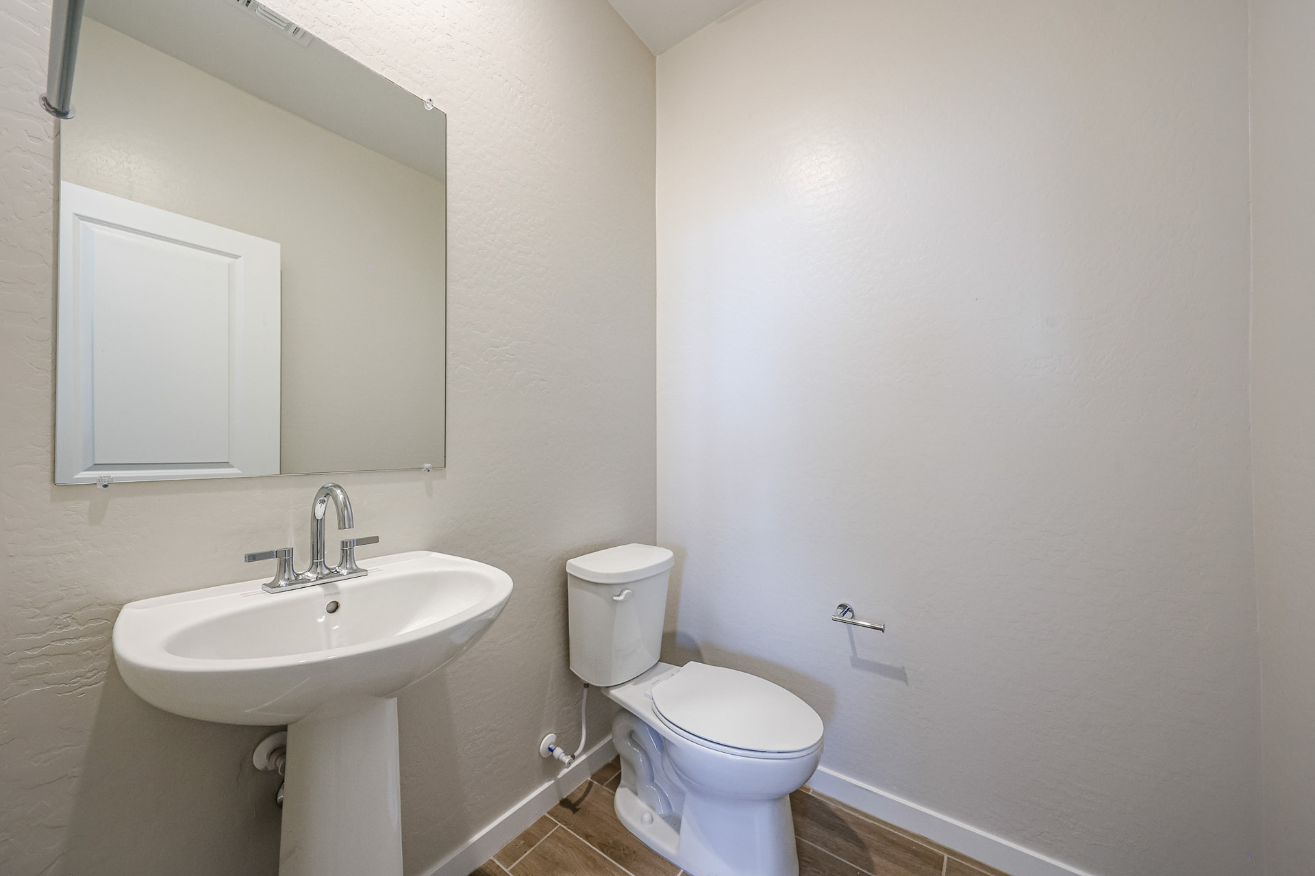 A bathroom with a toilet and sink.