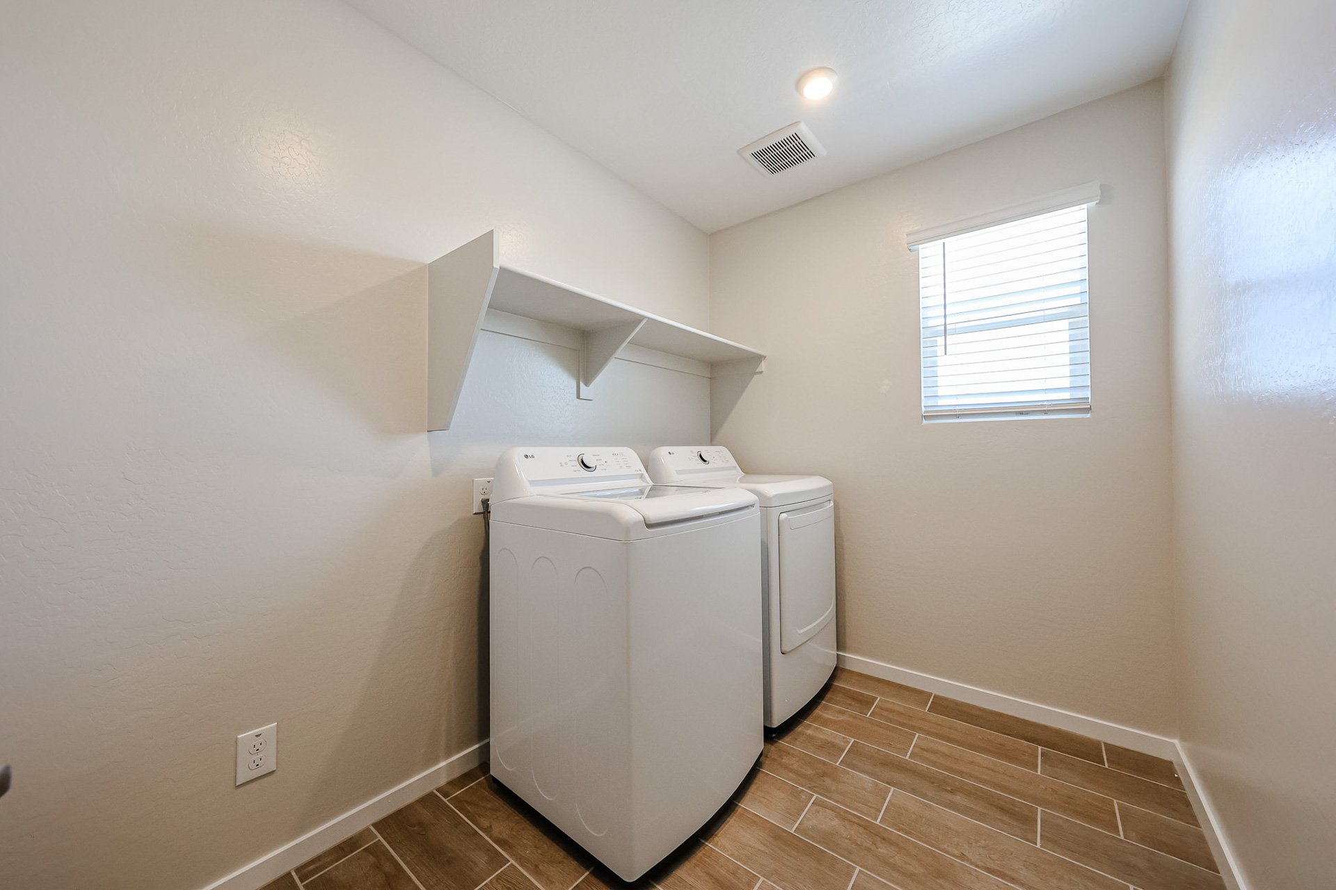 A room with a washing machine and a window.