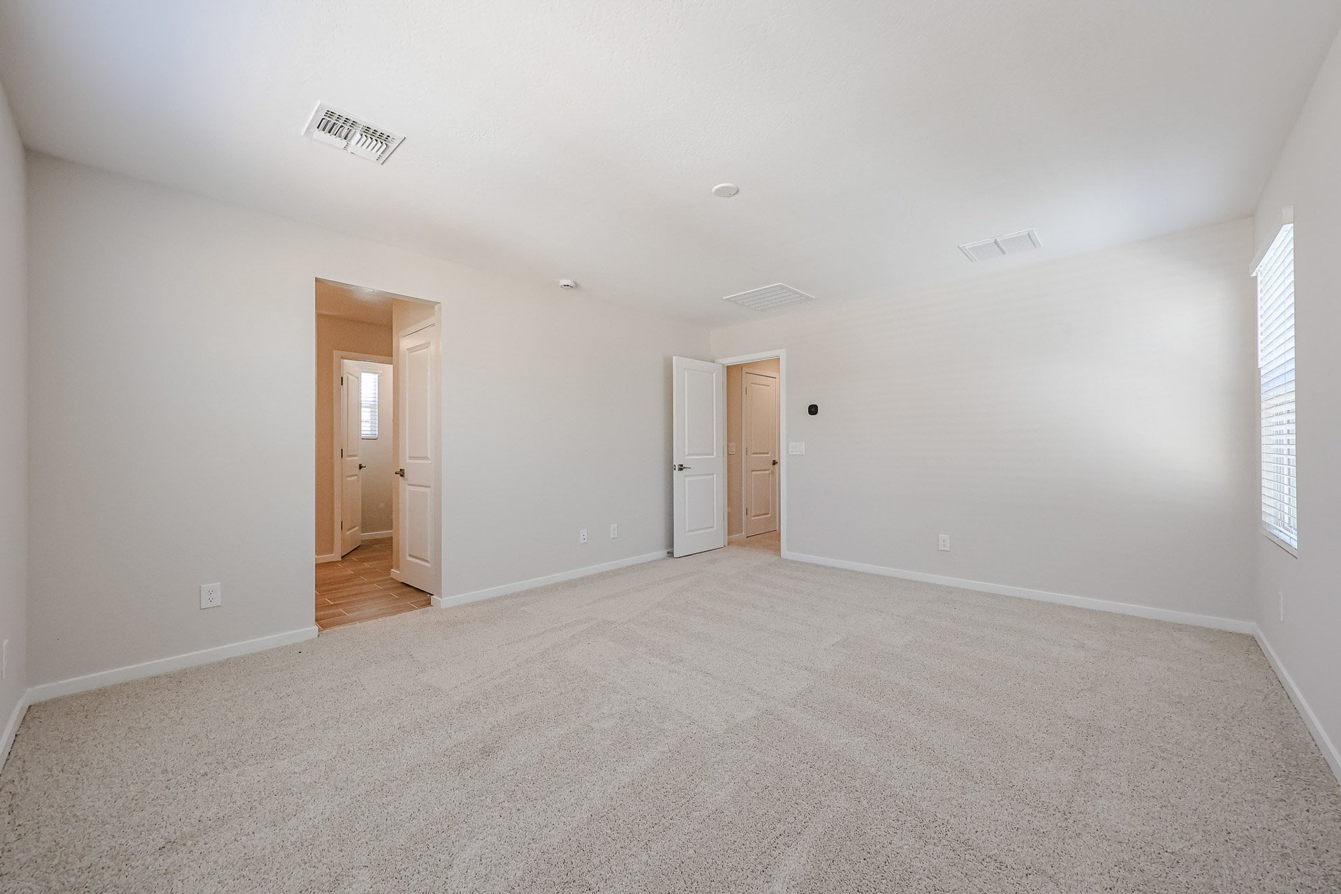 A room with white walls and doors.