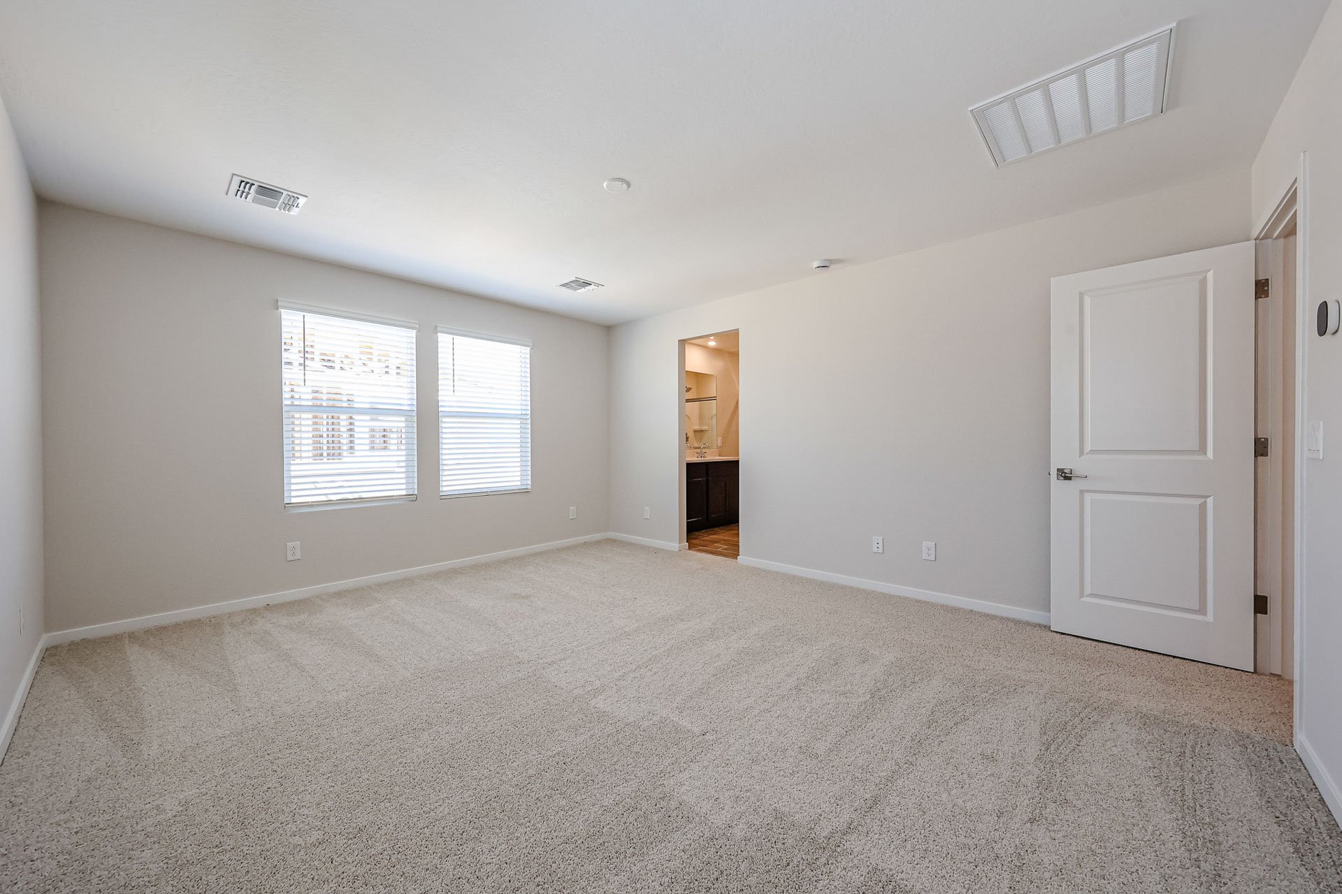 A room with white walls and a carpeted floor.