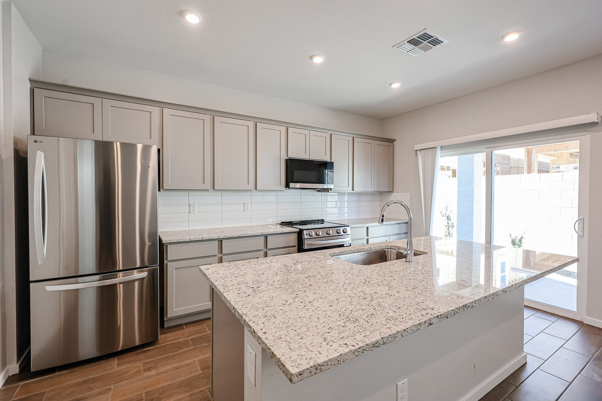 A kitchen with white cabinets.