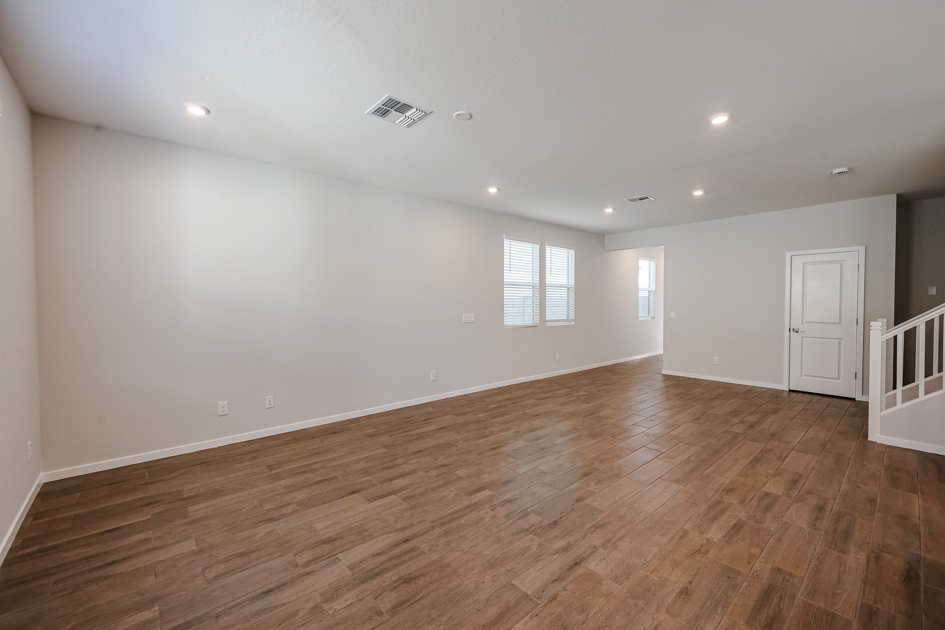 A room with a wood floor and a wood floor.