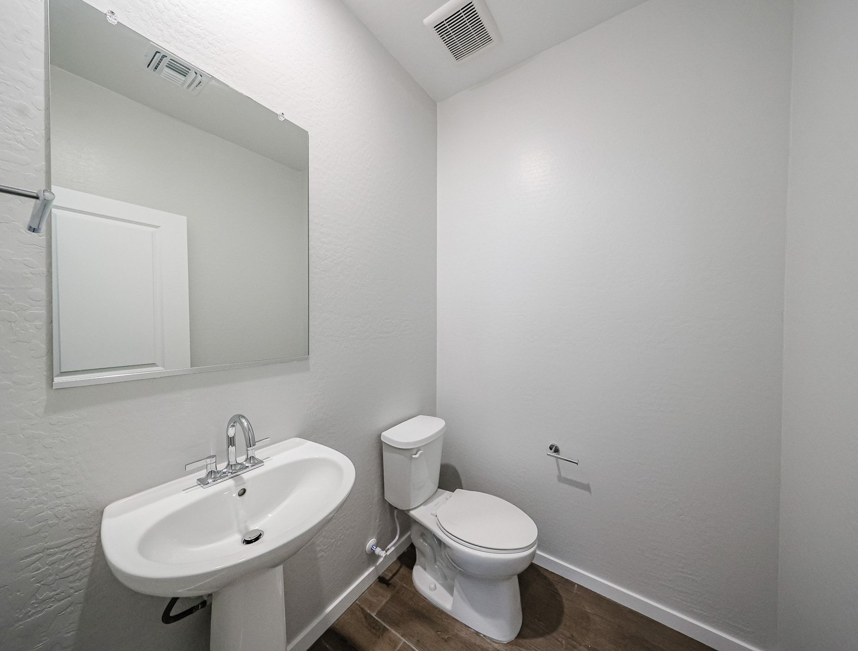 A bathroom with a toilet and sink.