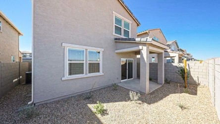A house with a stone patio.