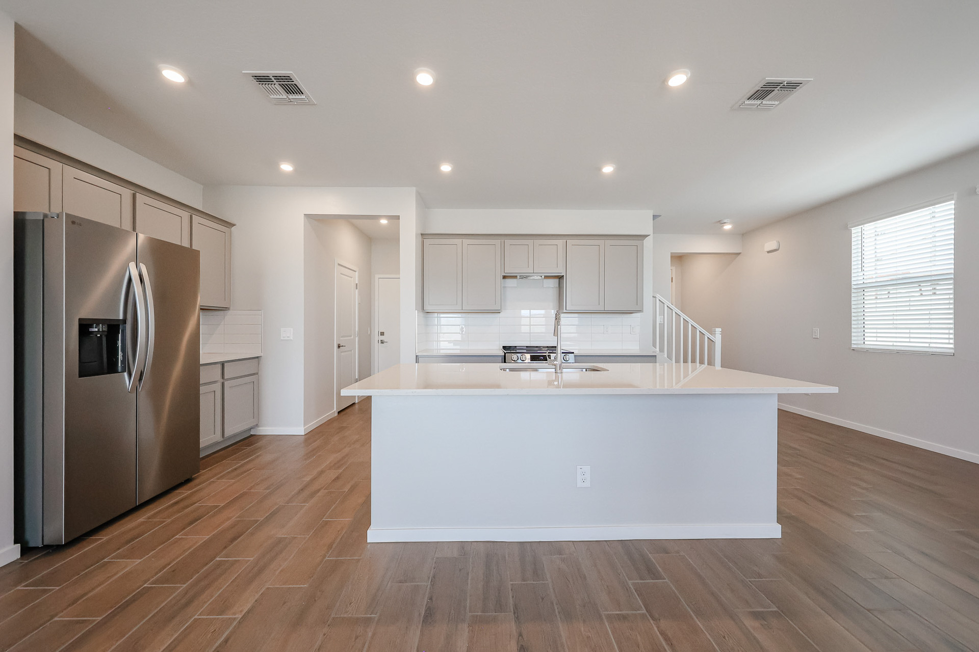 A kitchen with white cabinets.