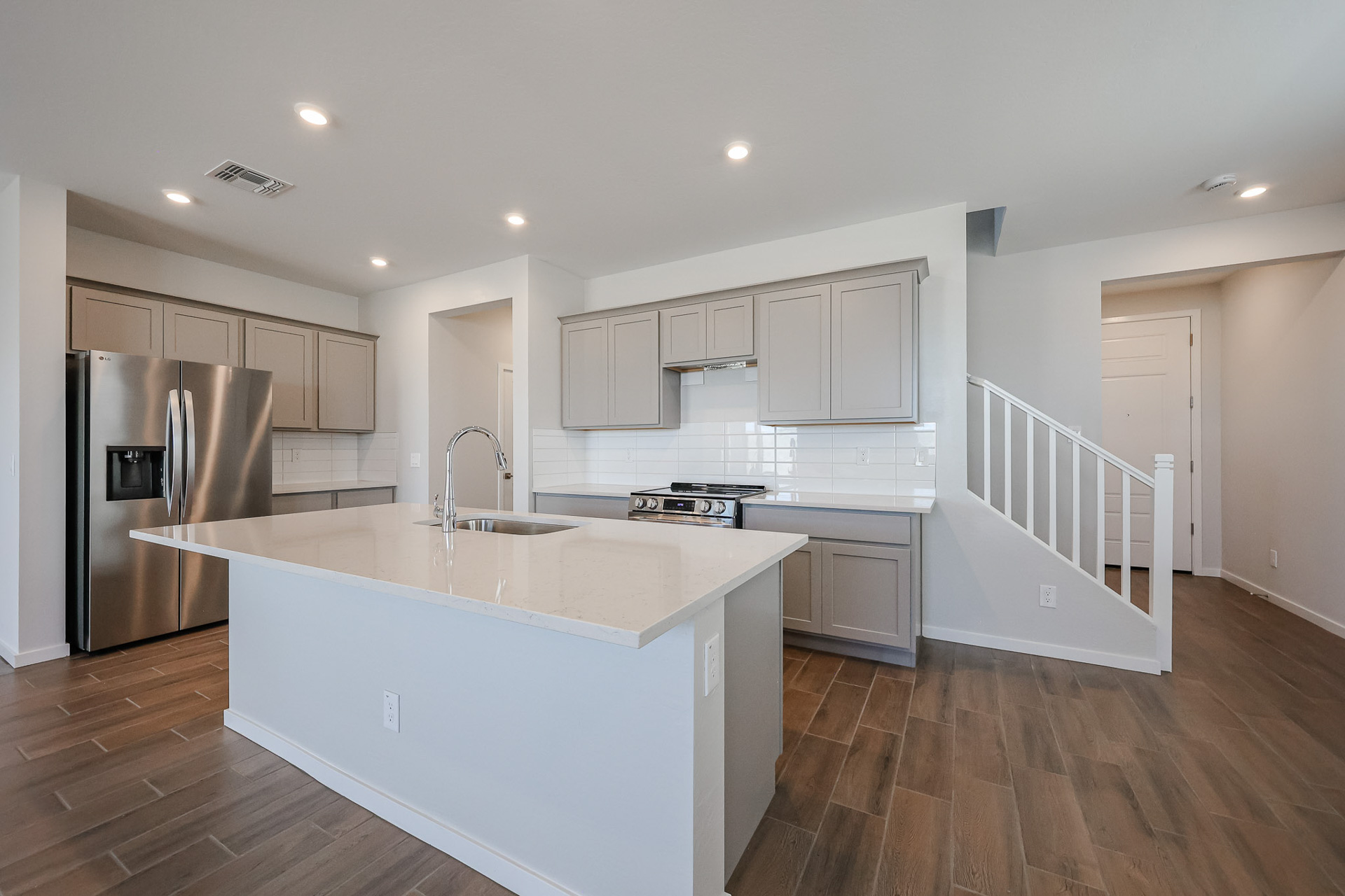 A kitchen with white cabinets.