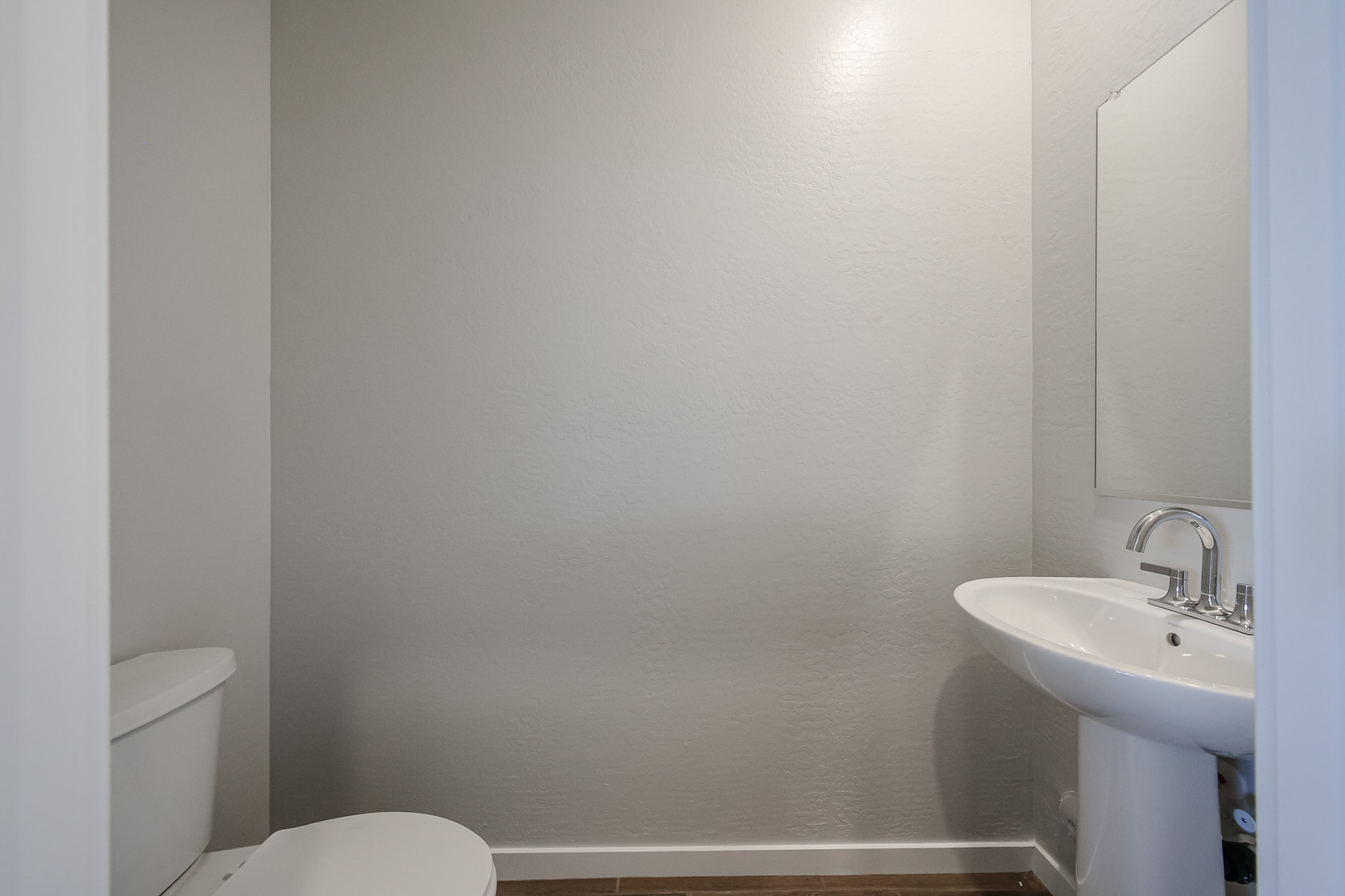 A bathroom with a sink and toilet.