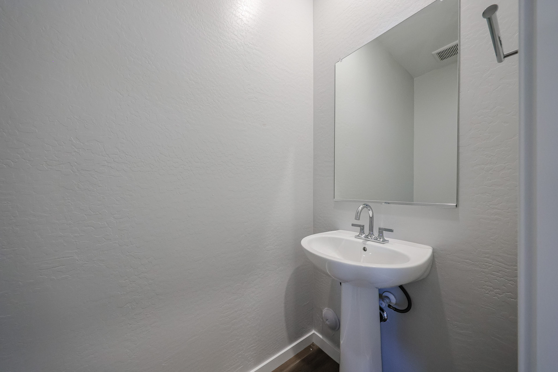 A bathroom with a mirror and sink.