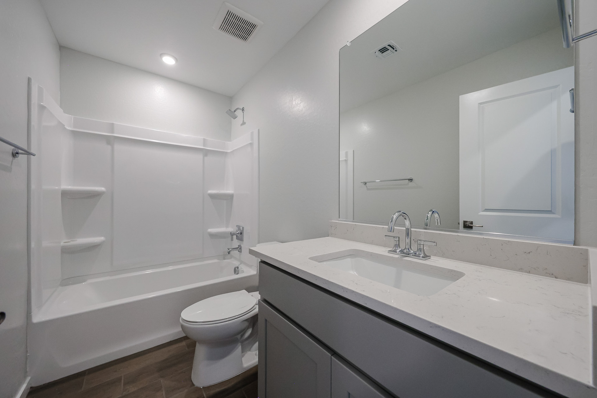 A bathroom with a tub sink and toilet.
