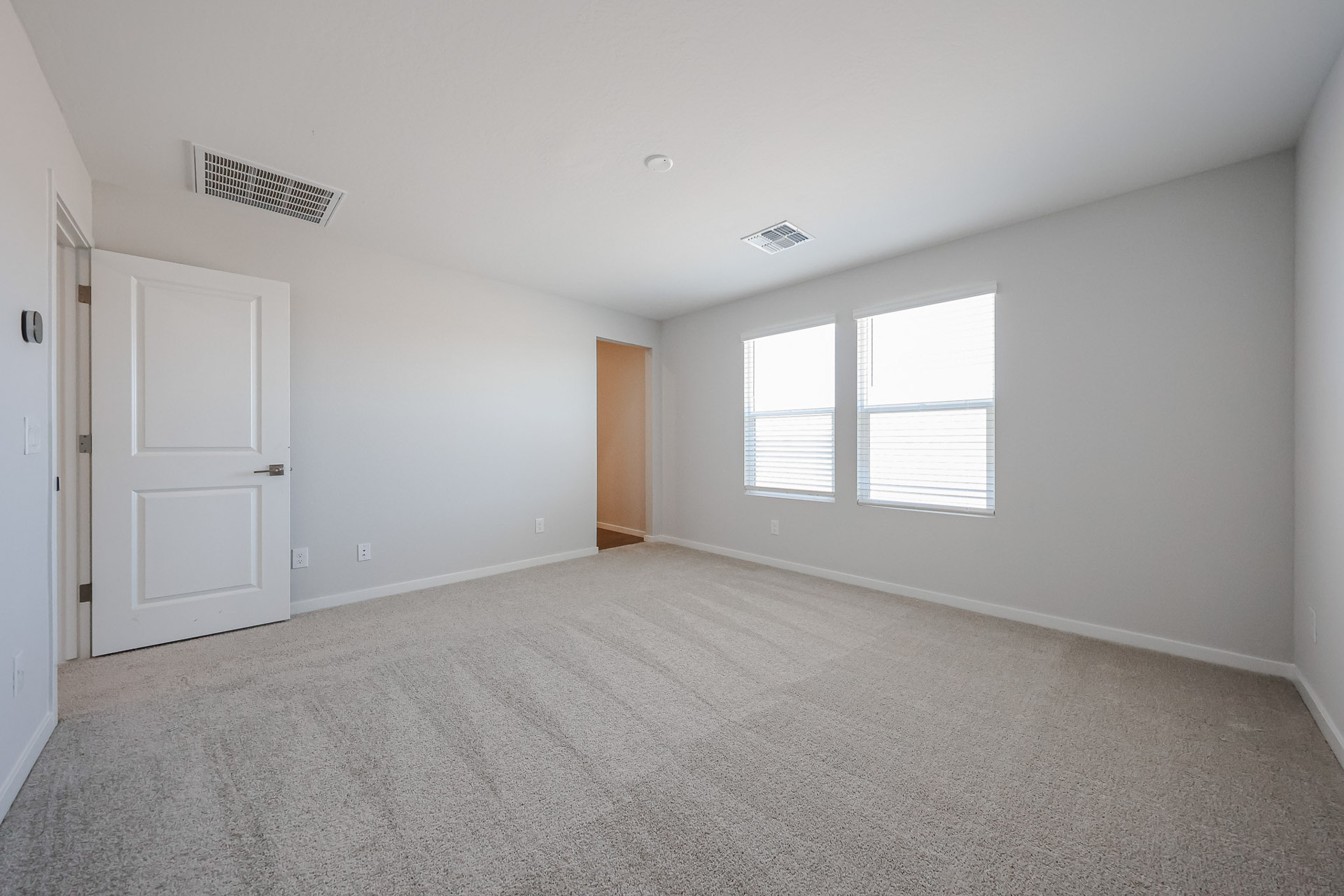 A room with white walls and a carpeted floor.