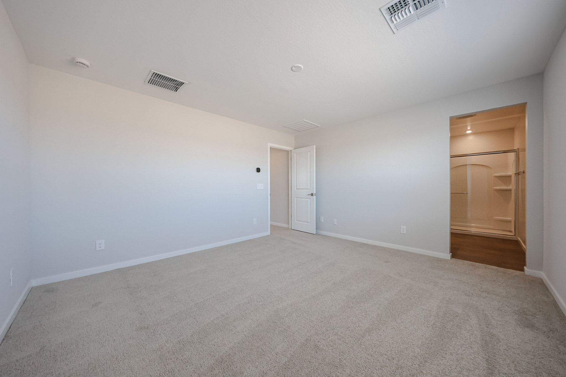 A room with white walls and a wood floor.
