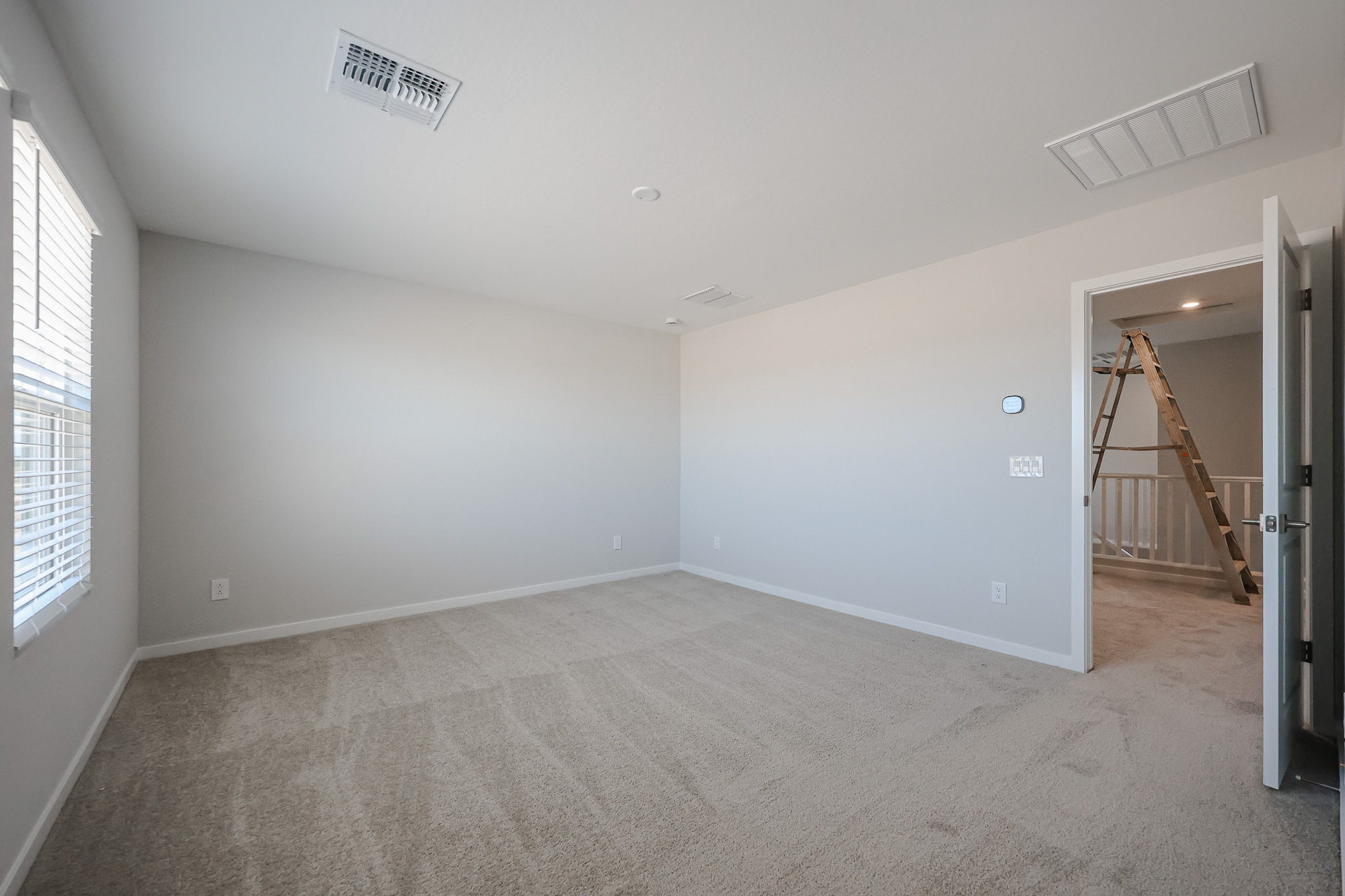 A room with a staircase and a window.