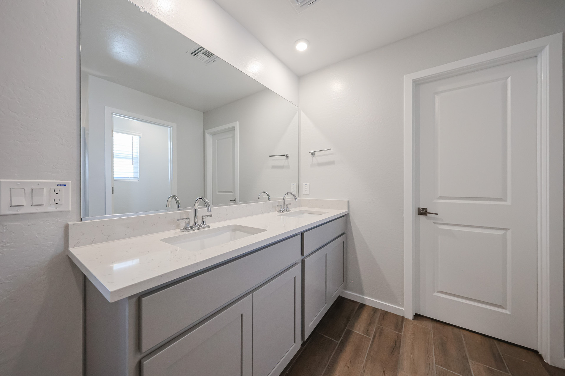 A bathroom with a large mirror.