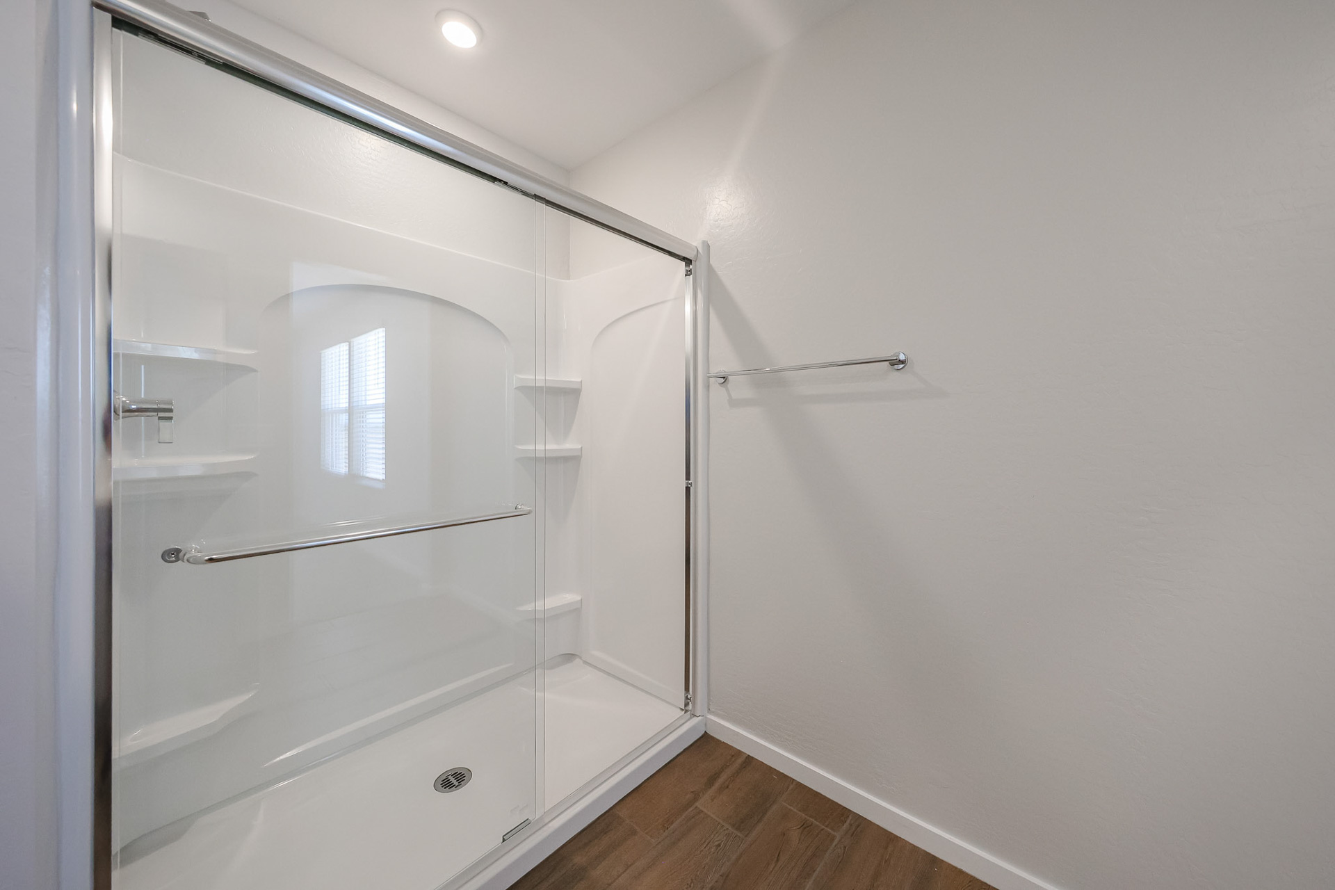 A shower with a glass door.