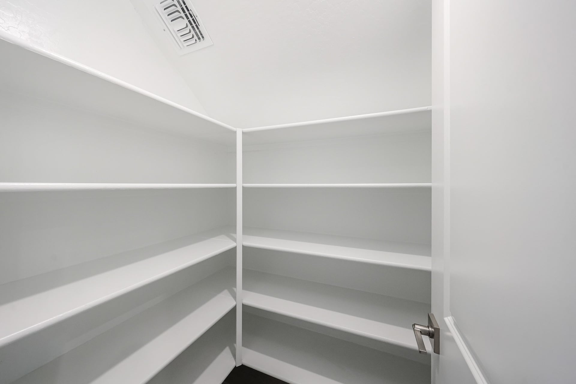 A white shelf with a sign on it.