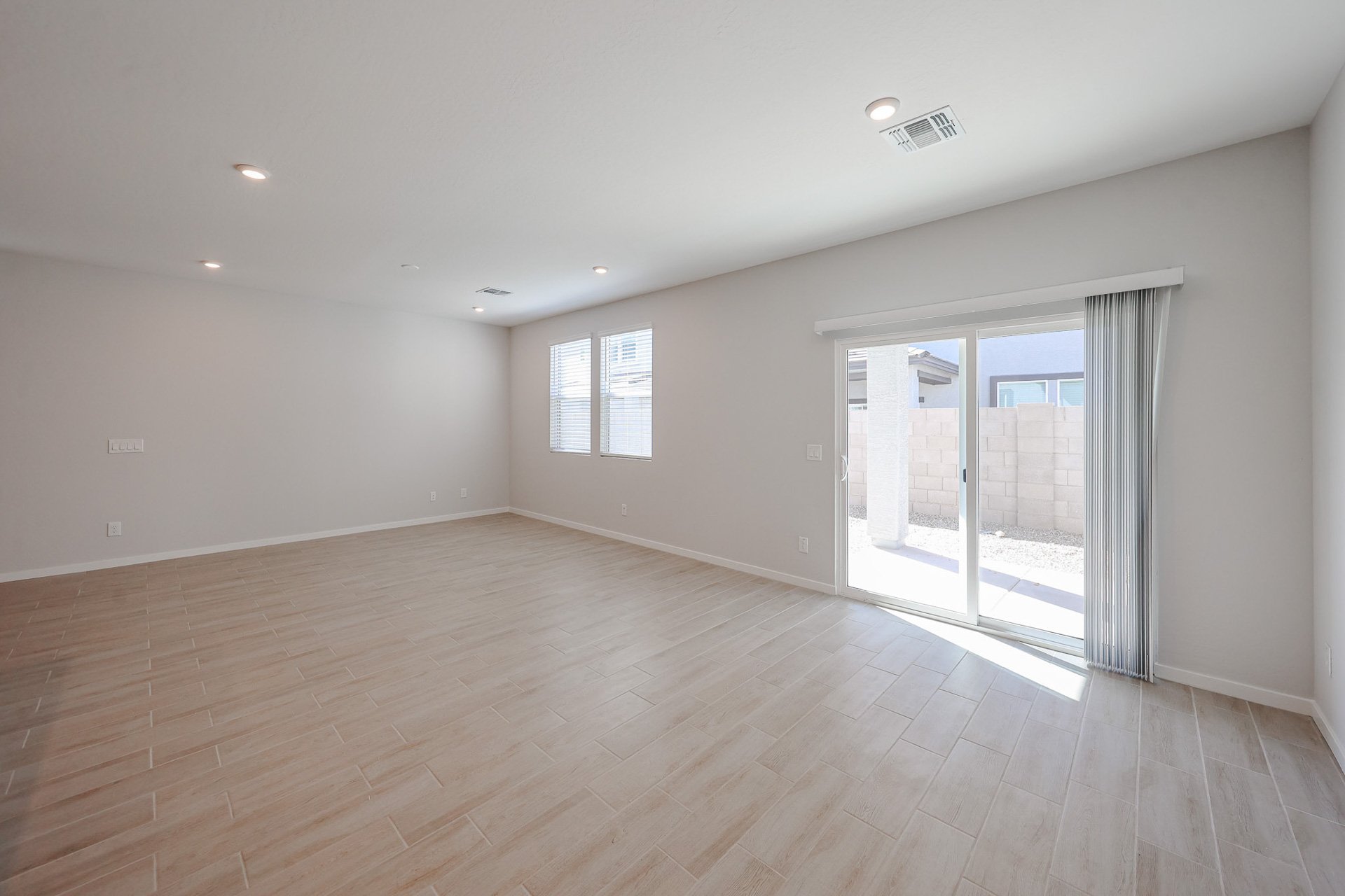 A room with a wood floor and a glass door.