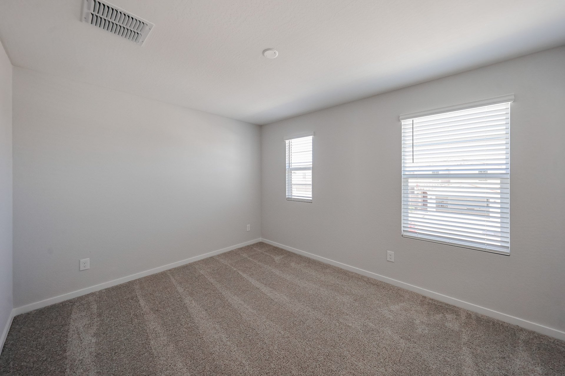 A room with a window and a carpet.