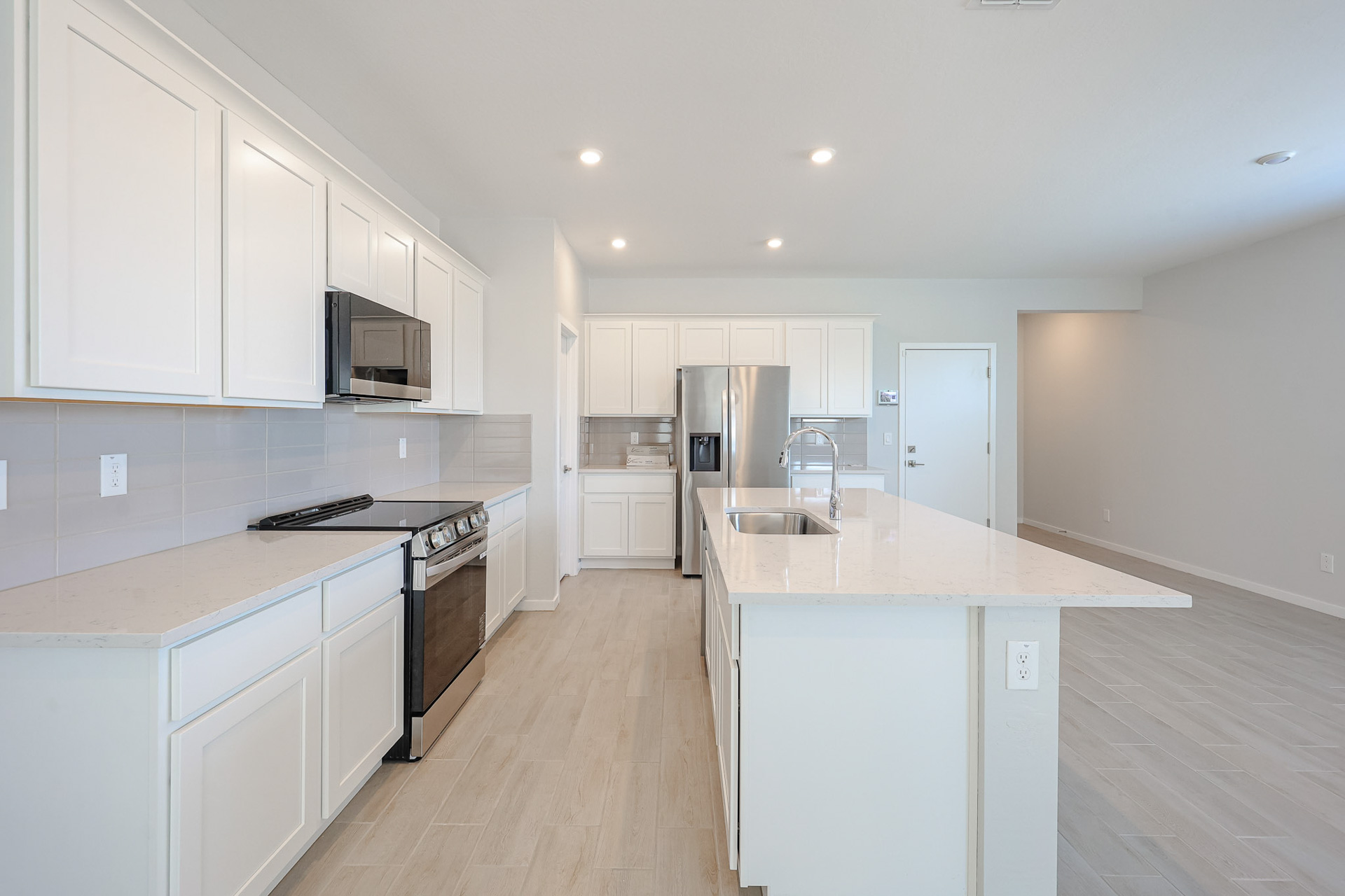 A kitchen with white cabinets.
