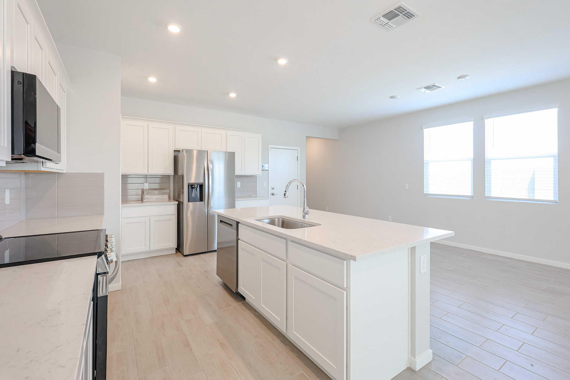 A kitchen with white cabinets.