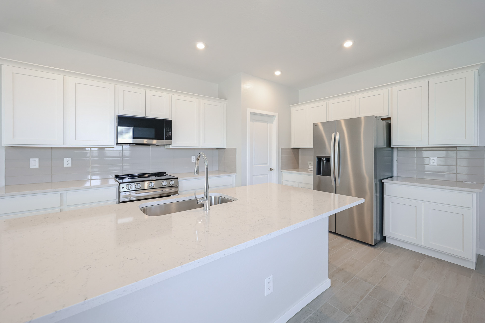 A kitchen with white cabinets.