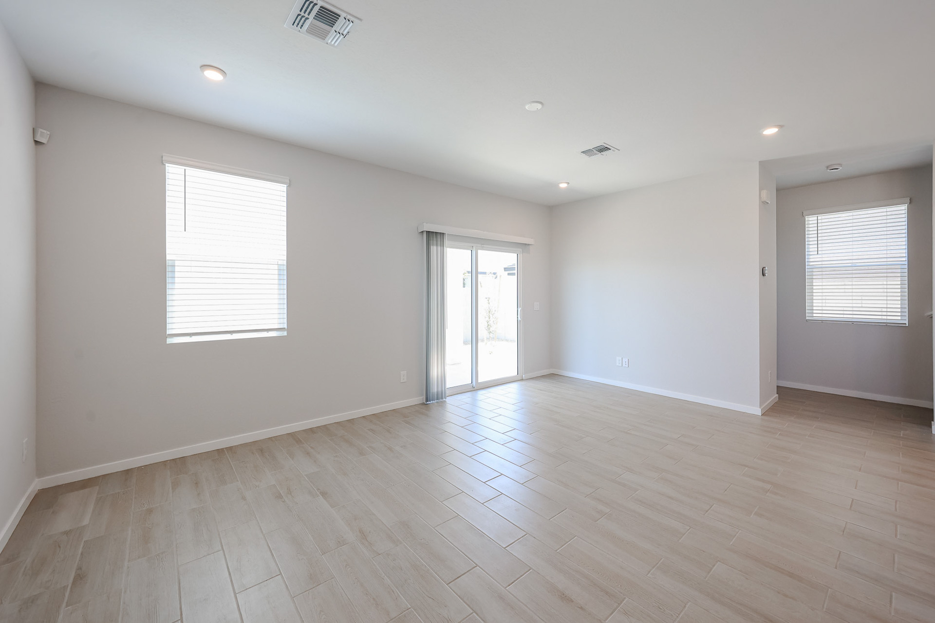 A room with a wood floor and white walls.