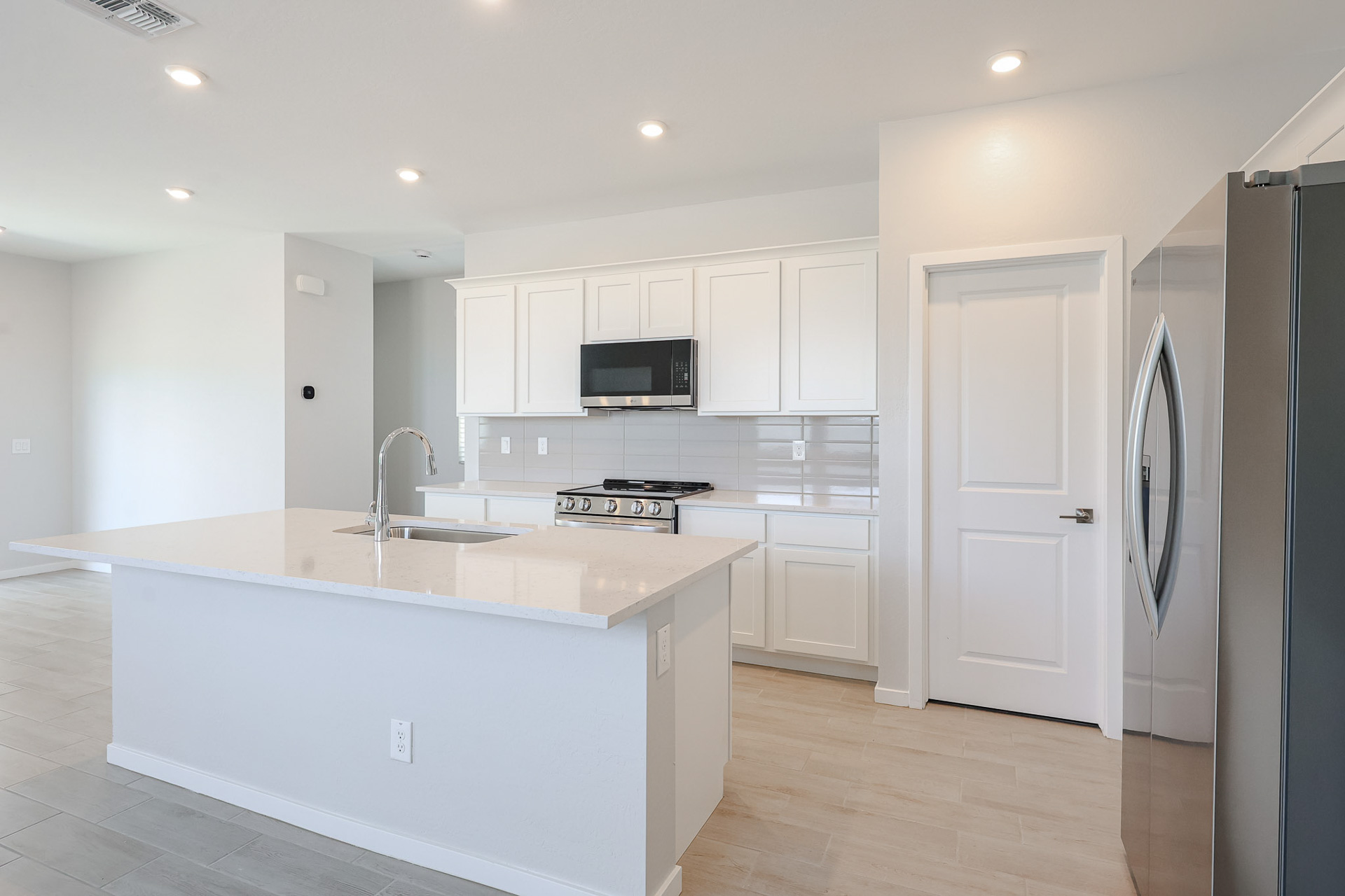 A kitchen with white cabinets.