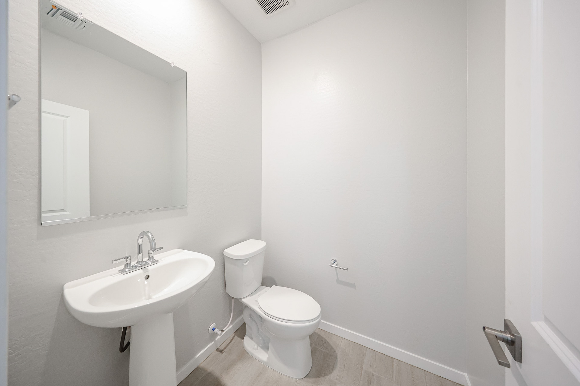 A bathroom with a toilet and sink.