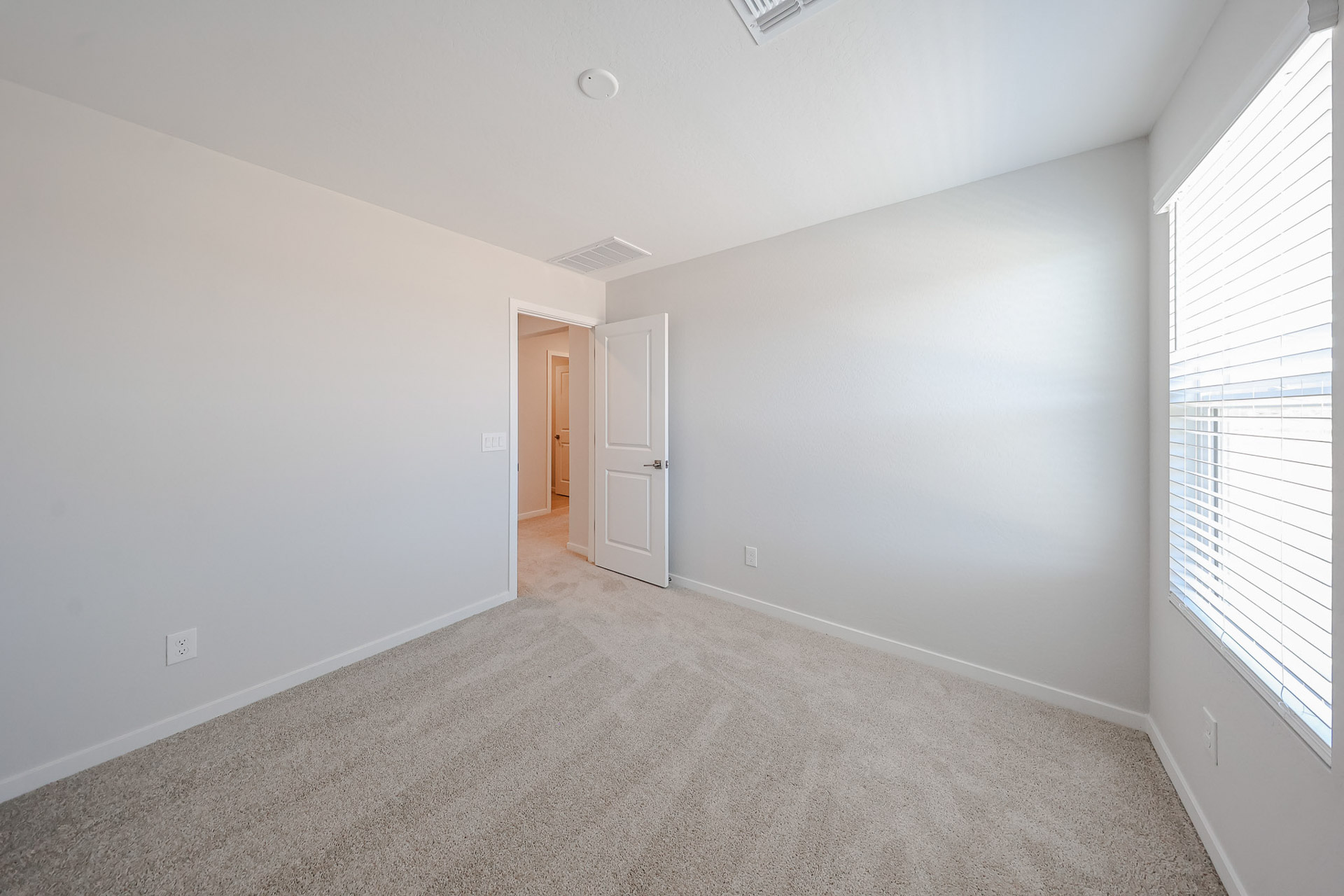 A hallway with white walls.