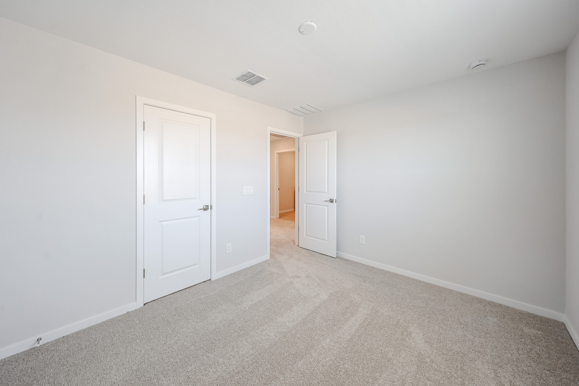 A hallway with white doors.
